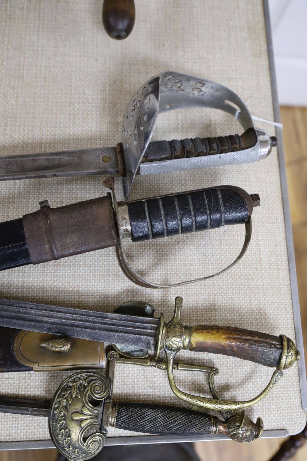 A 19th century European horn handled hunting hanger, a dress sword and three books